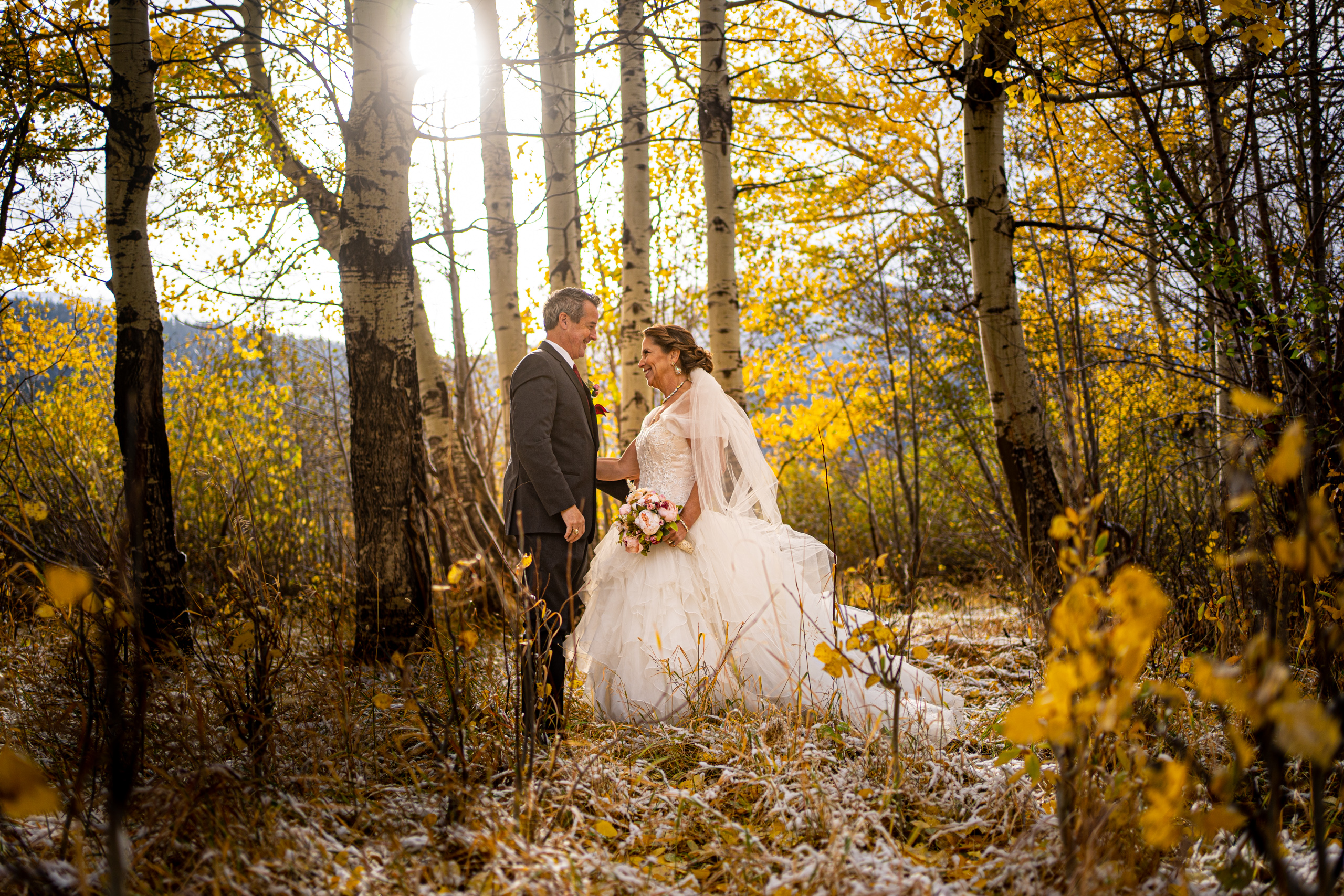 newly married couple surrounded by beautiful fall aspens in RMNP by colorado elopement photographer