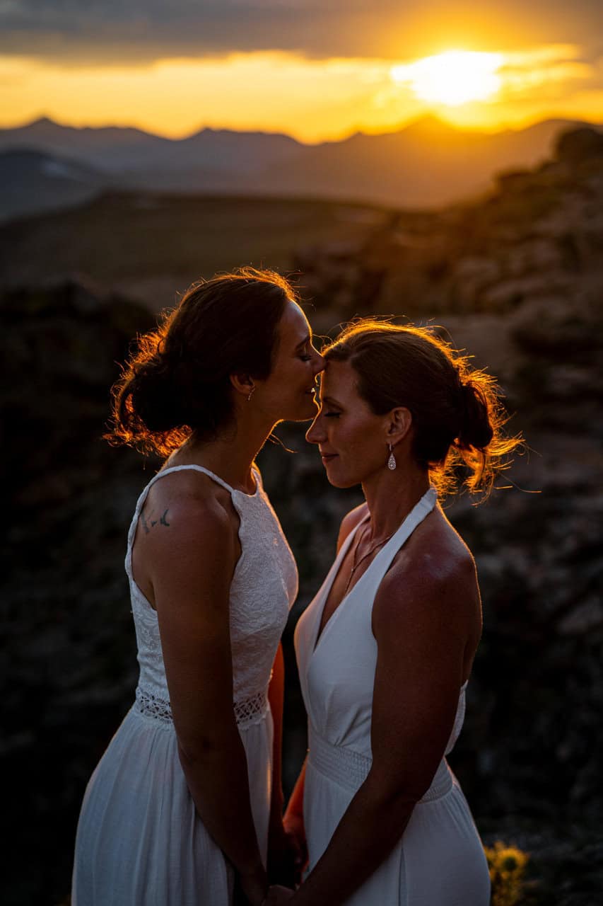 estes park photographer beautiful image of a lesbian couple kissing in the alpine in rocky mountain national park at sunset