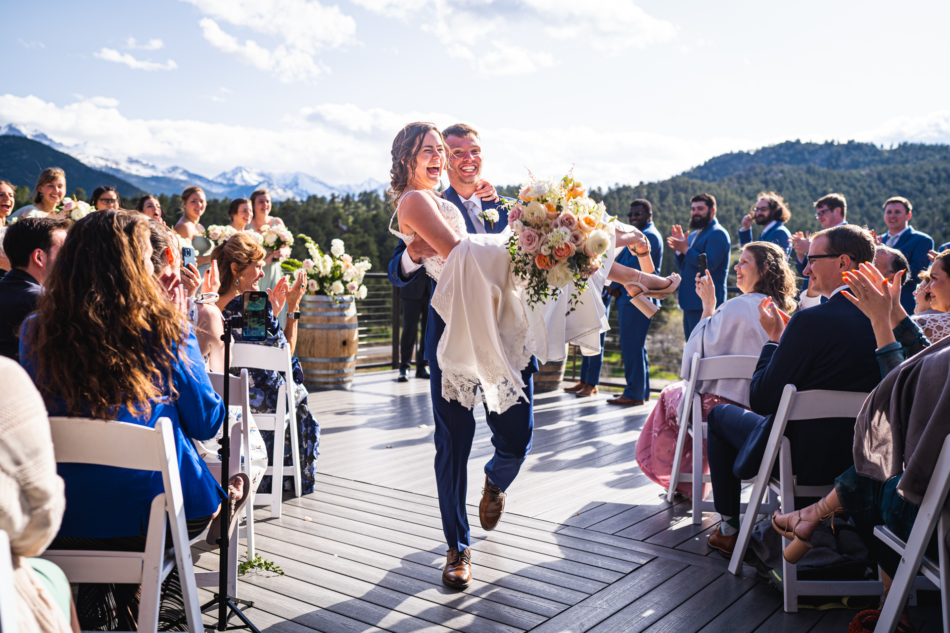groom and bride celebrating during recessional in estes park, Colorado