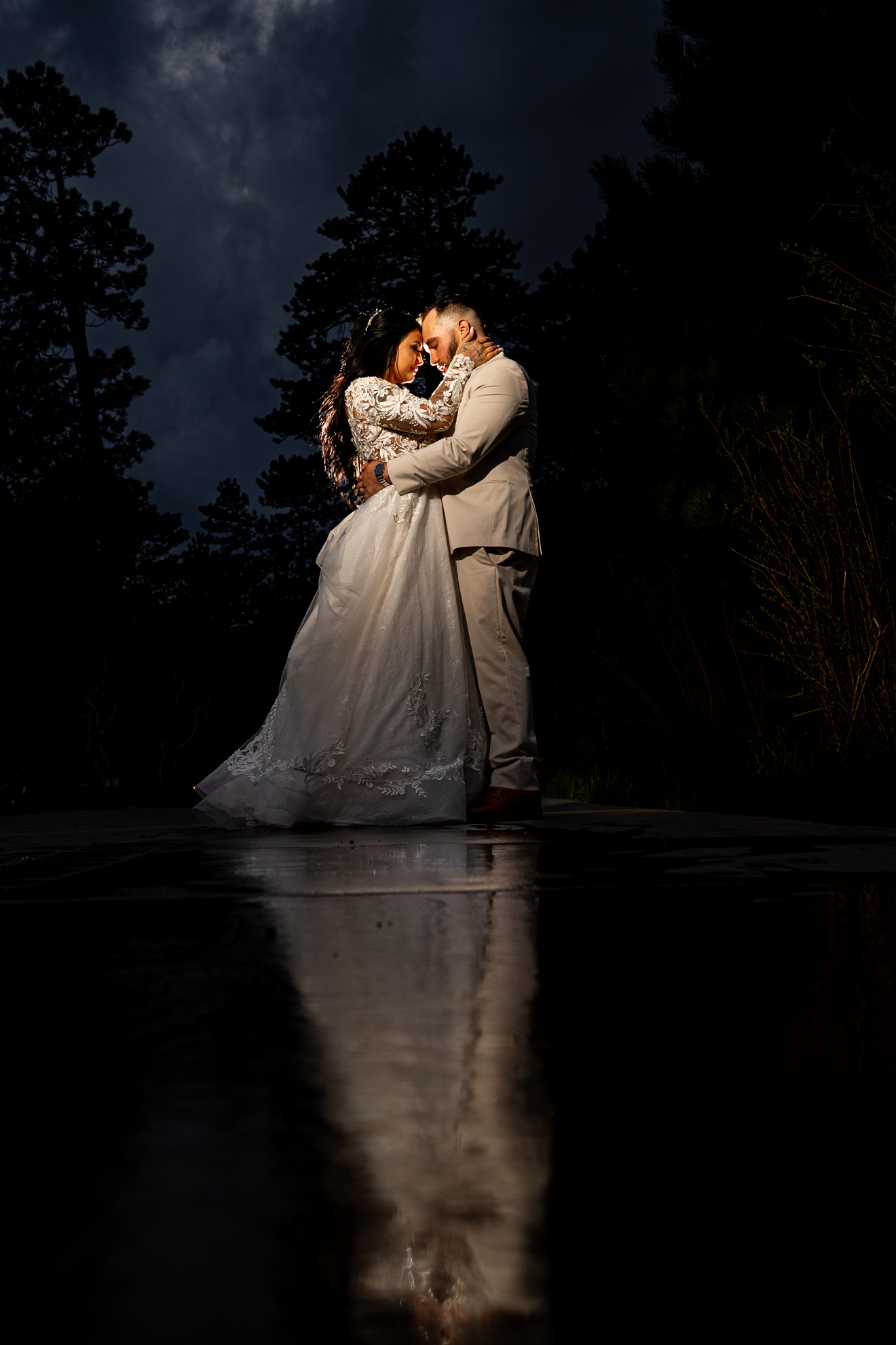 mountain elopement photographer newly married couple embracing at night with a beautiful reflection