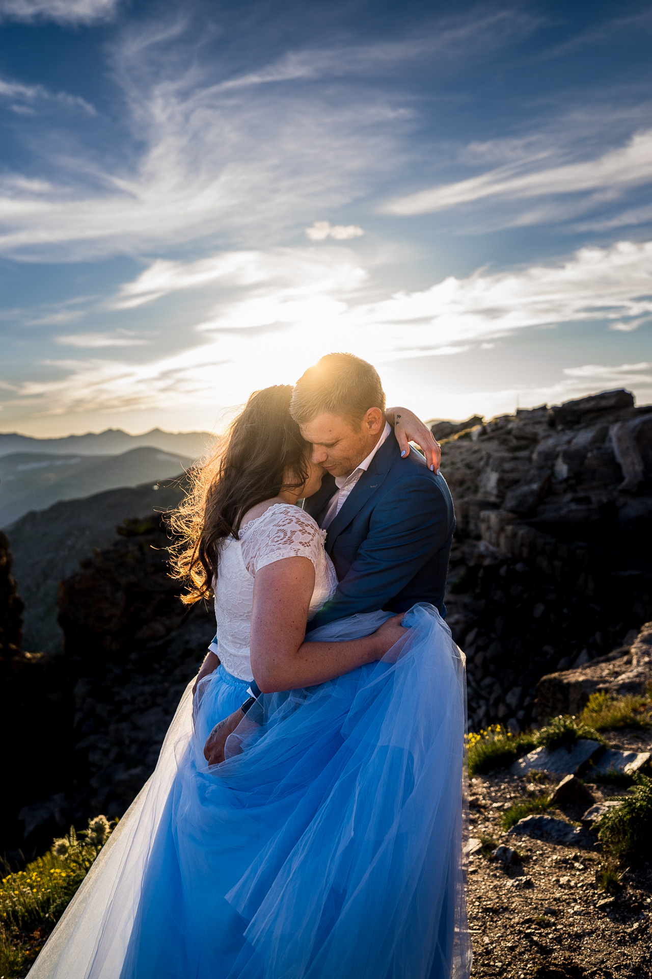destination elopement photographer captures couple embracing a 12,000 feet in RMNP