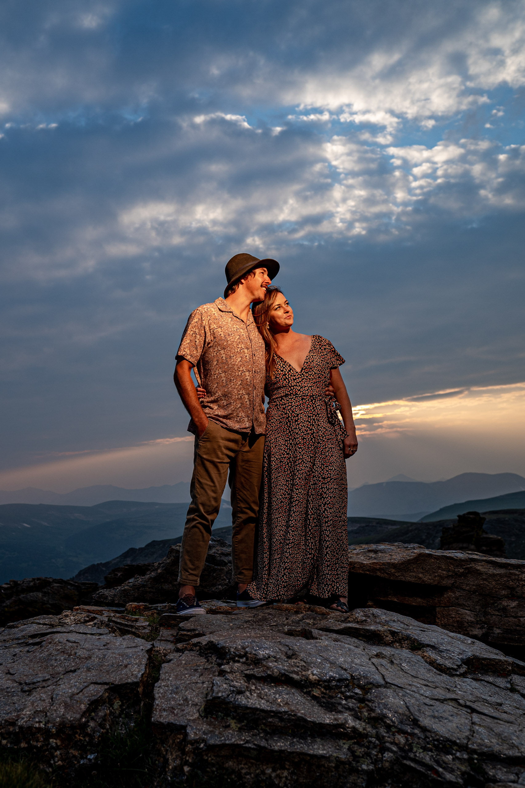 rmnp engagement photo at marmot point couple shares a laugh, captured by the estes park engagement photographer team