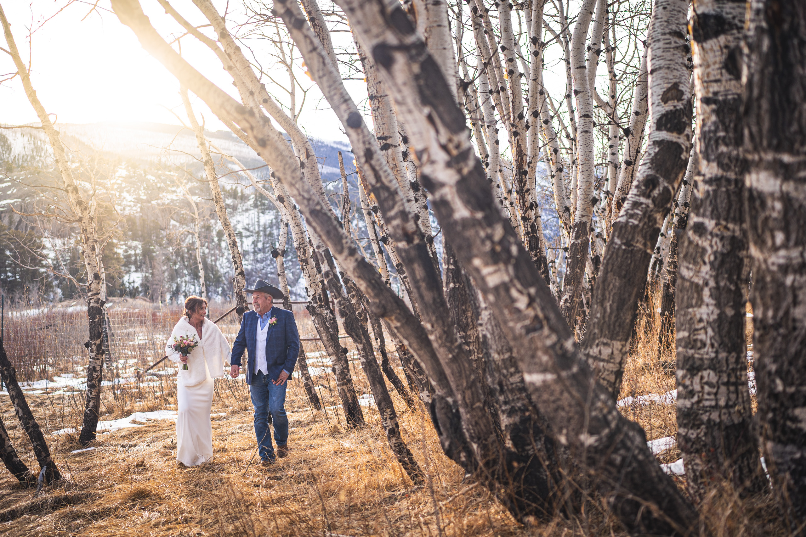cowboy couple in rmnp newly married couple walks in RMNP, captured by estes park wedding photographer