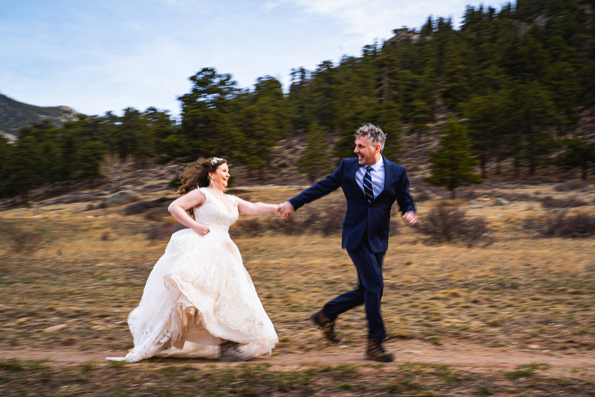 estes park wedding photographer captures couple running in rocky mountain national park