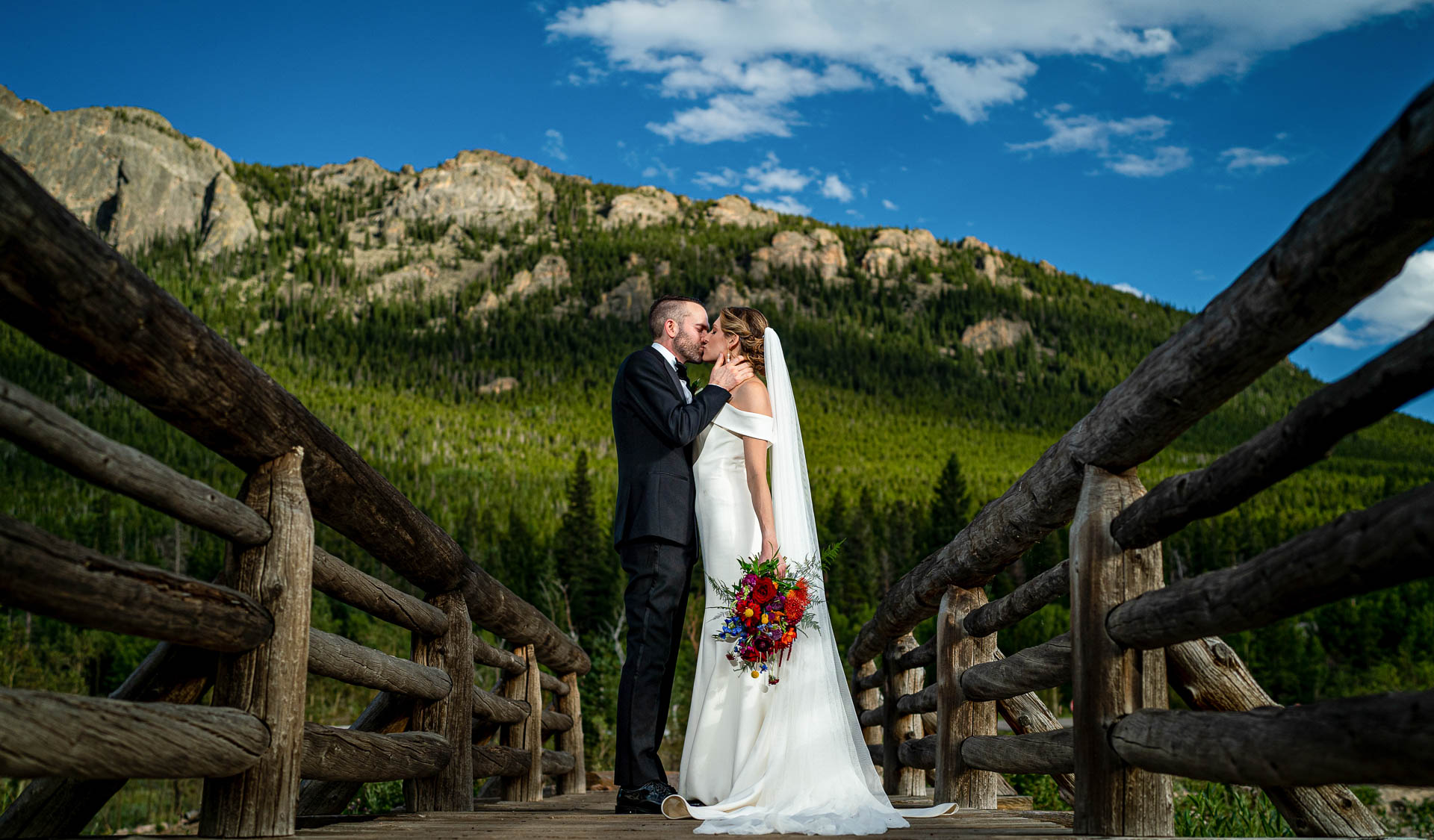 lily lake wedding photo on bridge by local estes park wedding photographers, joe and kari pyle