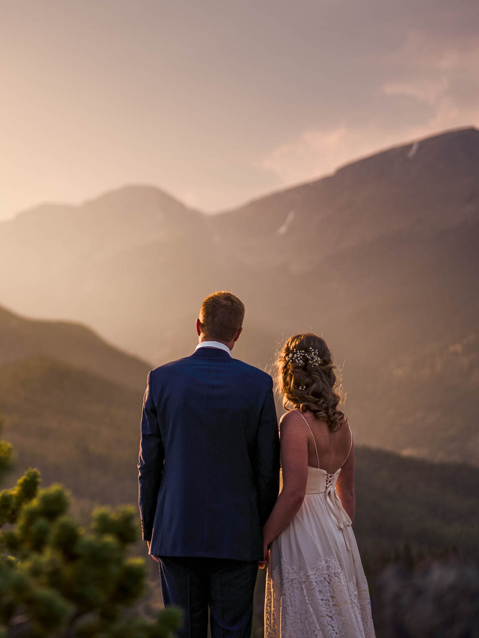 Bride and groom at sunset in Rocky Mountain National Park, captured by Colorado elopement photographers, Joe and Kari Pyle