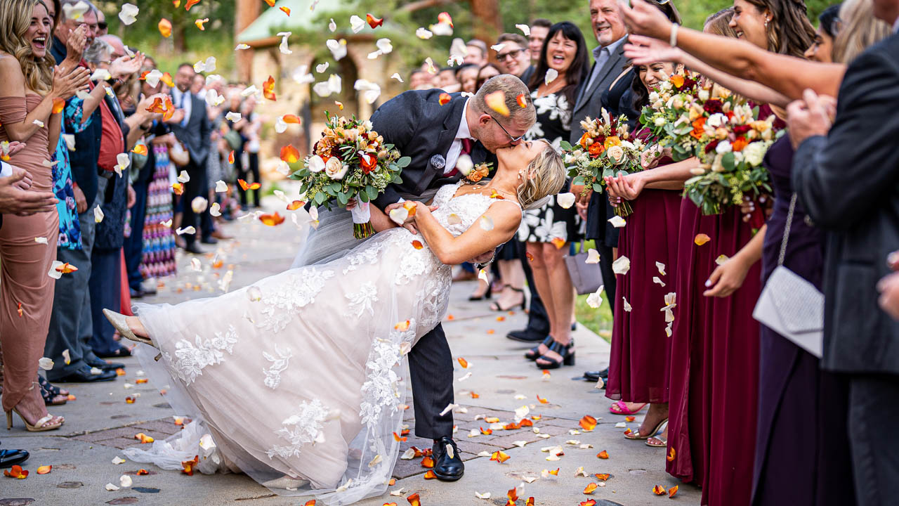 estes Park wedding photographer, Joe Pyle Photography, captures bride, father, and mother walking to her groom