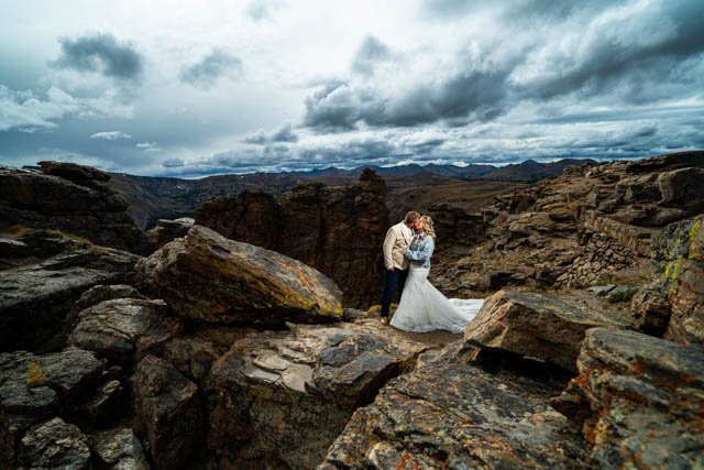 Estes Park wedding photographer, Joe Pyle Photography, captures couple in RMNP embracing at Rock Cut.